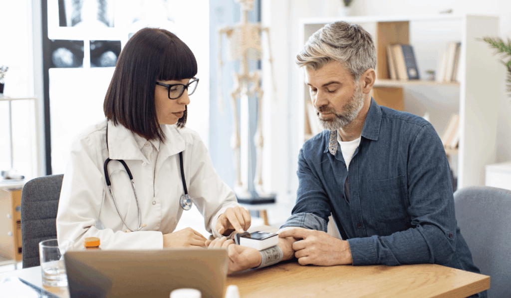 Doctor checking the blood pressure of a patient to detect hypertension symptoms early