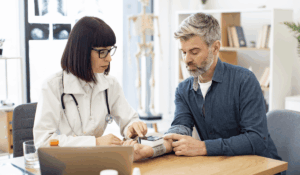 Doctor checking the blood pressure of a patient to detect hypertension symptoms early