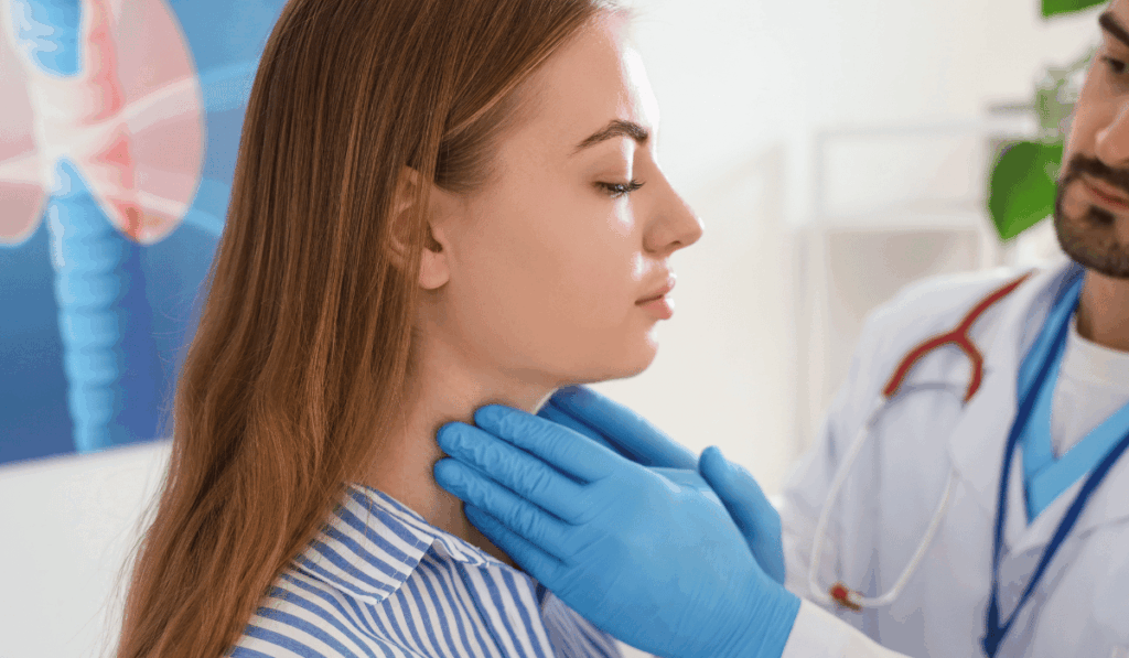 Doctor examining patient's neck for thyroid lump diagnosis and treatment