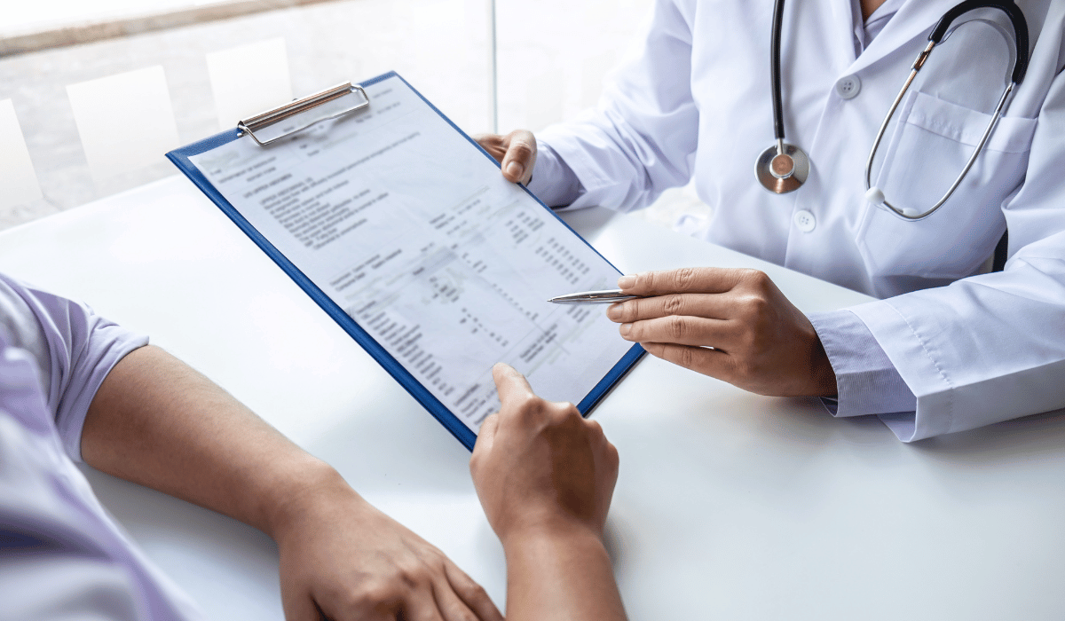 Doctor explaining LDL and HDL cholesterol levels to a patient at a free primary care clinic in Chicago