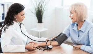 Doctor checking patient blood pressure at IAMACF free health clinic Chicago