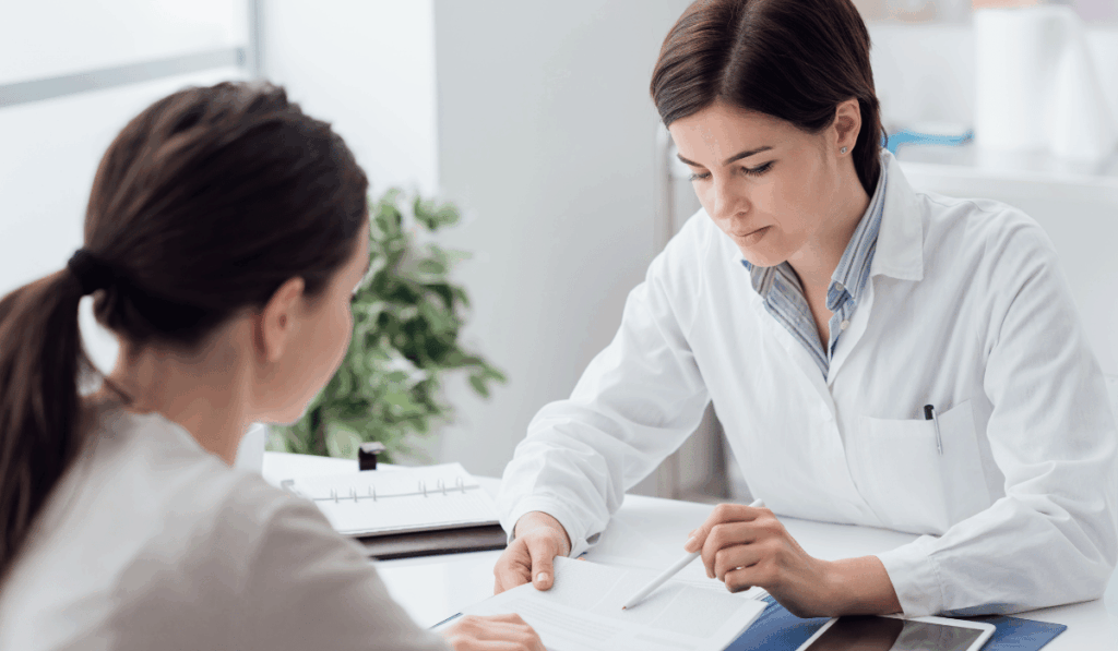 Doctor explaining chronic acid reflux symptoms to a patient at a free community health clinic in Chicago